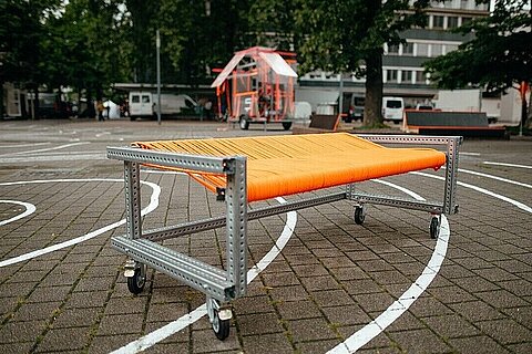An orange seating area made from Coroflex charging cables is set to be installed in a public space in Duisburg.