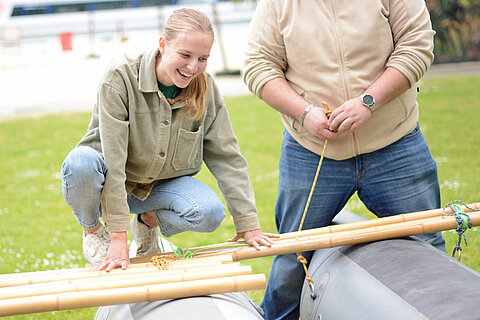 Apprentices building the raft and connecting the floats with bamboo sticks for this purpose