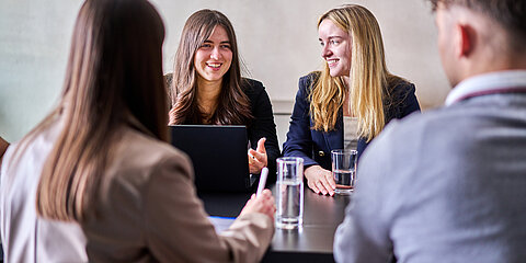 Young employees at the Coroplast Group at a high table