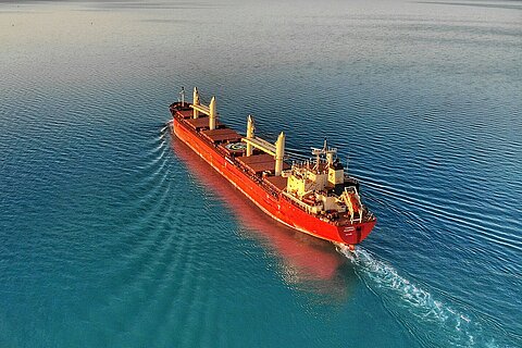 Red container ship on the high seas