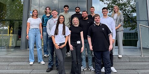 Eleven new apprentices in front of the main building
