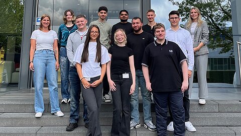 Eleven new apprentices in front of the main building