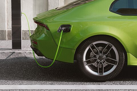 Coroflex charging cable connected to charging station and green vehicle