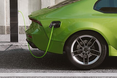 Coroflex charging cable connected to charging station and green vehicle