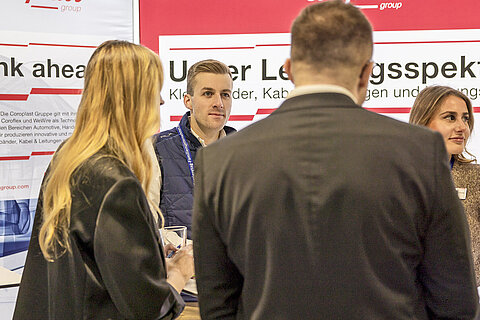 Visitors at the Coroplast Group booth engaging with our HR team